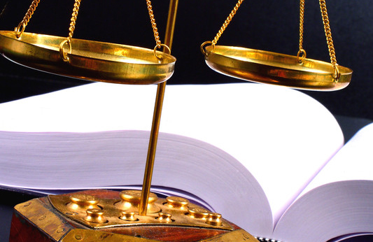 Justice scales in front of an open book