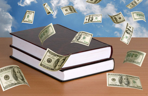 A stack of books with money floating in the air